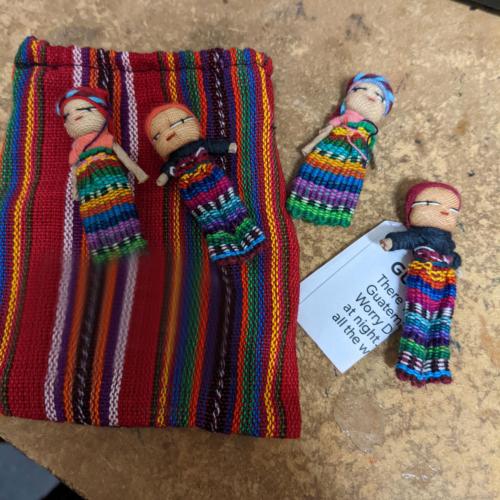 4 tiny worry dolls in bag