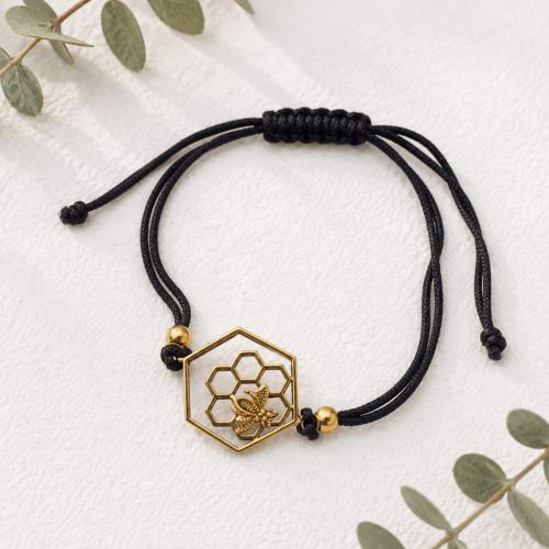Bracelet, gold colour, bee & honeycomb on brown cord