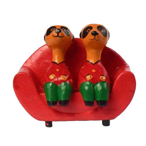 2 Meerkats on a red sofa hand carved from Albesia wood