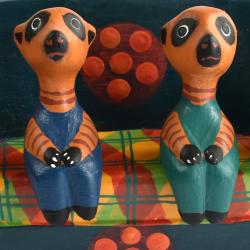 2 Meerkats in a floral sofa hand carved from Albesia wood,15 x 8 x 4cm 